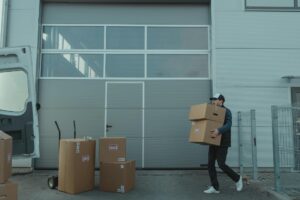 Man moving boxes for a business relocation using commercial moving services